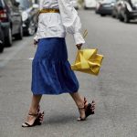 women is holding yellow bag