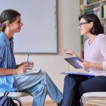 man taking therapy from women doctor