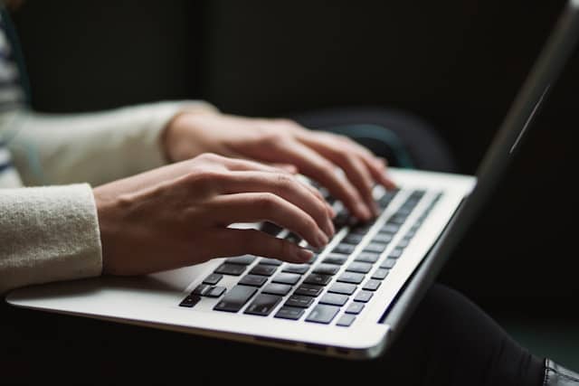 working Women hands on laptop