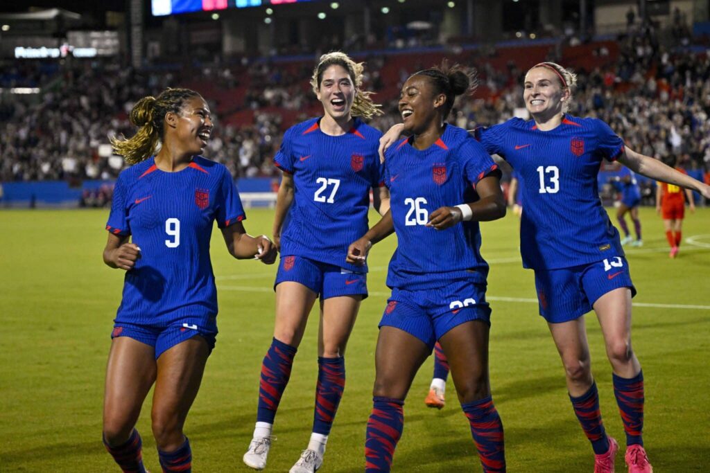 women soccer team in blue with numbers